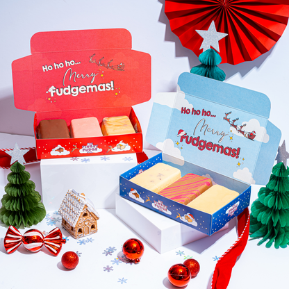 Two Christmas-themed fudge boxes with festive decorations on a white background